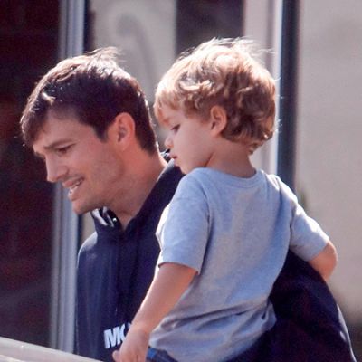 Ashton is carrying Dimitri as they are going somewhere.